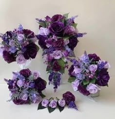 purple flowers and greenery arranged in a circle