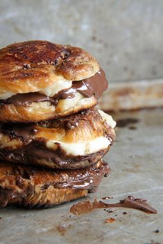 three chocolate covered pastries stacked on top of each other