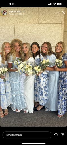 a group of women standing next to each other holding bouquets in their hands and smiling