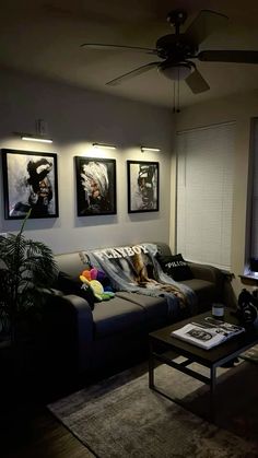 a living room filled with furniture and pictures on the wall above it's coffee table