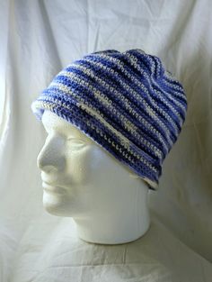 a white mannequin head wearing a blue and white striped knitted beanie