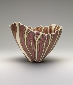 a white and red vase sitting on top of a table