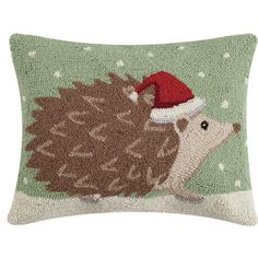 a hedge pillow with a santa hat on it