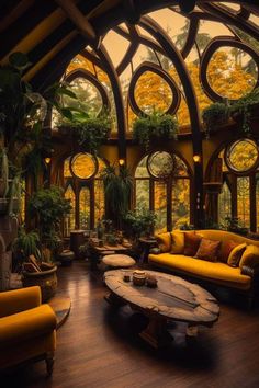 a living room filled with yellow couches and windows covered in plants on top of wooden flooring