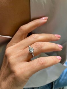 a woman's hand with a diamond ring on it