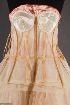 the back of a woman's dress, with straps and an attached brale