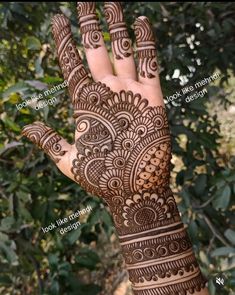 the hand is decorated with henna designs