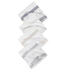 four white napkins stacked on top of each other