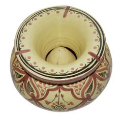 a ceramic vase with an intricate design on it's side and inside the lid