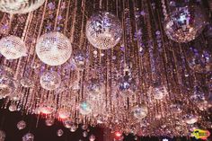 disco ball chandelier hanging from the ceiling in a room with lights on it