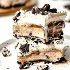 three pieces of ice cream and oreo cake on a white plate with chocolate chips