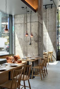 an empty restaurant with wooden tables and chairs