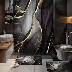 a modern bathroom with black and gold decor