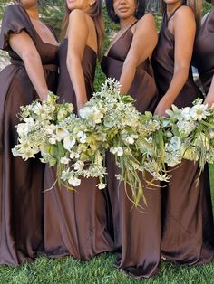 the bridesmaids are wearing brown dresses and holding their bouquets