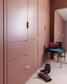 a pair of shoes is sitting on the floor in front of a dresser and mirror