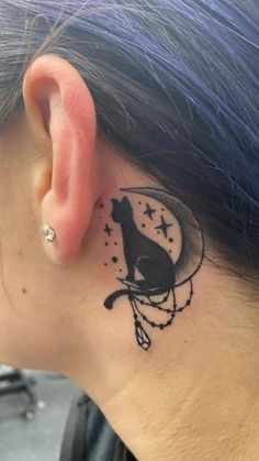 a woman with a cat tattoo on her behind the ear