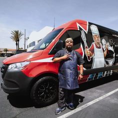 a man standing in front of a van that is painted like a chef and holding a knife