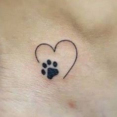 a small paw print in the shape of a heart on top of a woman's stomach