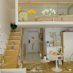 a small room with stairs leading up to the top floor and a loft bed above it