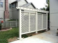 a white trellis on the side of a house