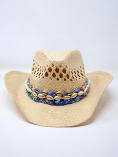 Our Coastal Cowgirl Straw Hat is perfect for a day at the beach or a summer festival. Adorned with a hand braided fabric and hand beaded cowrie shells – each cowgirl hat band is unique and one of a kind! Material: StrawSize: 4" deep, brim approx 3.5", approx 23" around Handmade Bohemian Straw Hat For Kentucky Derby, Handmade Panama Hat For Kentucky Derby, Bohemian Panama Hat For Kentucky Derby, Western Style Sun Hat For Kentucky Derby And Beach, Bohemian Panama Hat For Kentucky Derby And Rodeo, Western Hat Bands For Kentucky Derby Vacation, Western Style Hat Bands For Kentucky Derby, Bohemian Hats For Beach And Kentucky Derby, Bohemian Panama Hat For Beach And Kentucky Derby