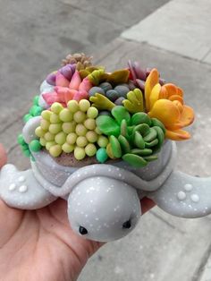 a small turtle with flowers in it's shell