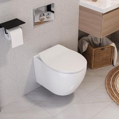 a white toilet sitting in a bathroom next to a sink and towel dispenser