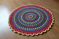 a multicolored round rug on the floor