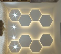 a room with some lights on the ceiling and walls in different shapes, sizes and colors