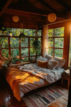 a bed sitting in the middle of a room with lots of windows