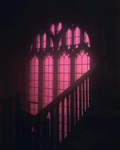 the light is shining through two windows in an old building with stairs leading up to it