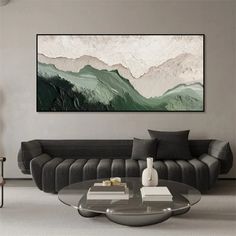 a living room with a couch, coffee table and painting on the wall above it