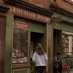 a woman standing in front of a book store