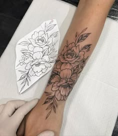 a woman's arm with flowers on it