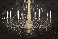 a chandelier is shown with white and gold paint splattered on it