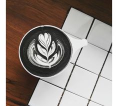 a cappuccino with a leaf drawn on it