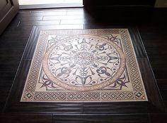 a white and black area rug sitting on top of a wooden floor next to a window