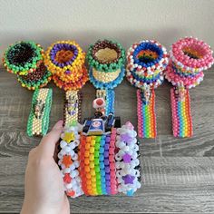 a hand holding a bunch of colorful beaded bracelets