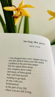 an open book with some flowers in the background and writing on it that says loving the gone sara tan