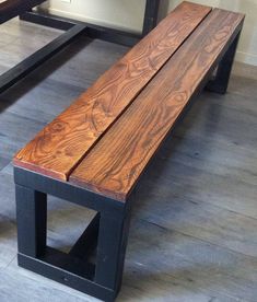 a wooden bench sitting on top of a hard wood floor