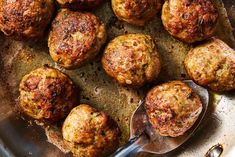 cooked meatballs in a pan with a spoon