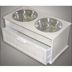 two bowls on top of each other in a white cabinet