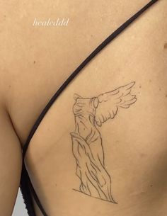 the back of a woman's breast with an angel tattoo on it