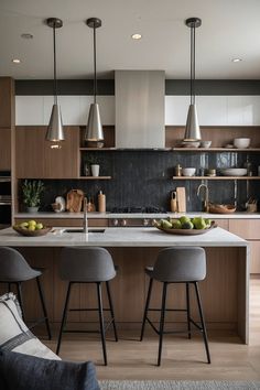 a kitchen with two stools next to an island