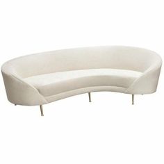 a white curved couch sitting on top of a wooden table