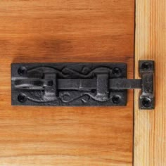 an iron latch on a wooden door