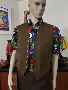 This vest is well made in a golden brown wool with a six button closure with pearly buttons and chest and hip pockets. It also has a wool reverse and acetate lining. The condition is good except for a pinhole on the front ( see photo) Size is small. Measurements are Chest 92cm Length 55cm Tailored Brown Business Vest, Brown Single-breasted Sleeveless Vest, Brown Sleeveless Single-breasted Vest, Brown Wool Vest For Workwear, Brown Wool Vest For Work, Fitted Brown Wool Vest, Retro Wool Sleeveless Vest, Fitted Brown Vest With Button Closure, Tailored Single-breasted Brown Vest