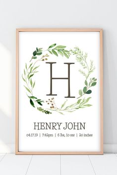 a framed print with the letter h and leaves on it