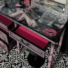 a vanity with lipstick on it and a mirror over the top that has pink accents