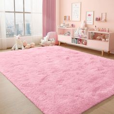 a child's bedroom with pink walls and carpet, teddy bears on the floor